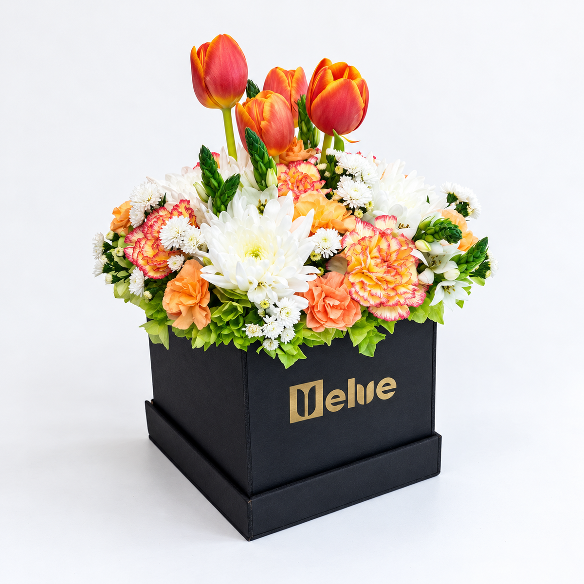 Arreglo de tulipanes anaranjados, claveles y crisantemos blancos en caja negra, vista lateral. Velve Floristería, Paseo de las Flores, Heredia.